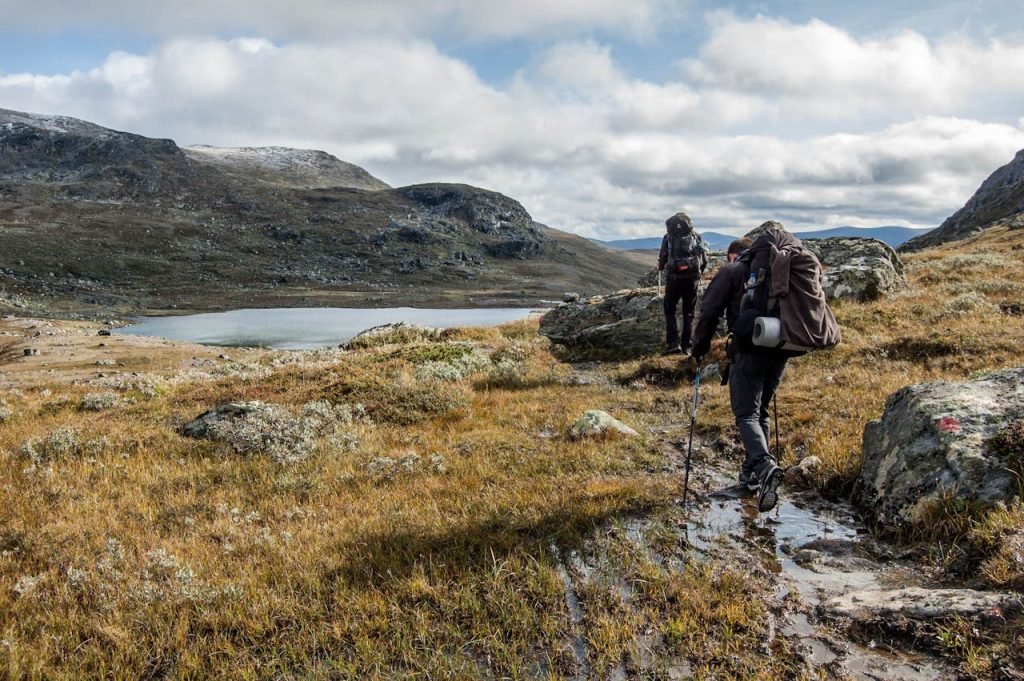 exploration-and-mountain-climbing-3669288 Adventurous hikers explore the scenic Vålådalen landscape in Sweden during fall.